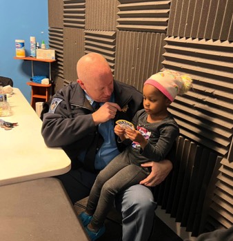  Chatting with a Junior Deputy at the Lexington Park Boys and Girls Club Holiday Gathering. 